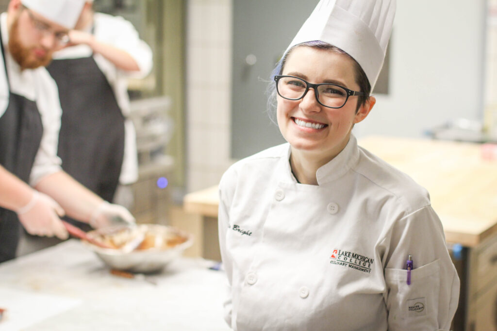 A chef smiling at the camera.