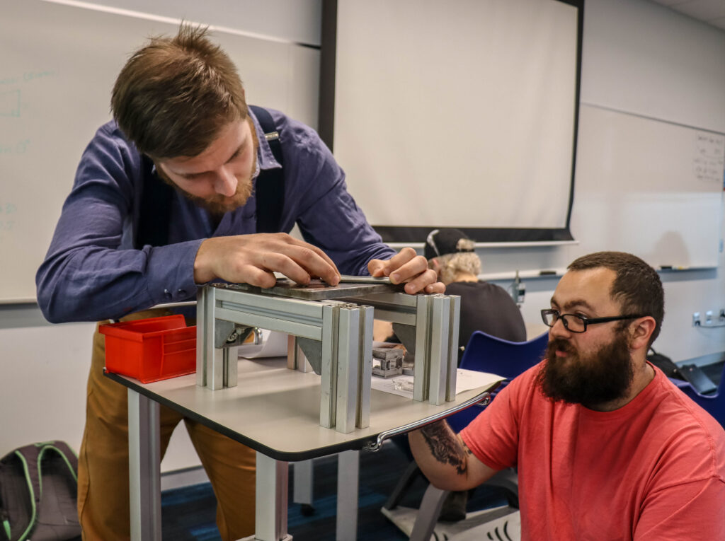 Two engineering students working together on a project.