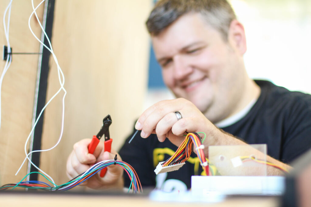 Man experimenting with wires.