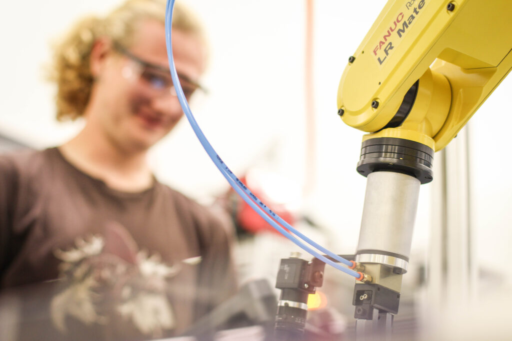 A woman watching a machine work.