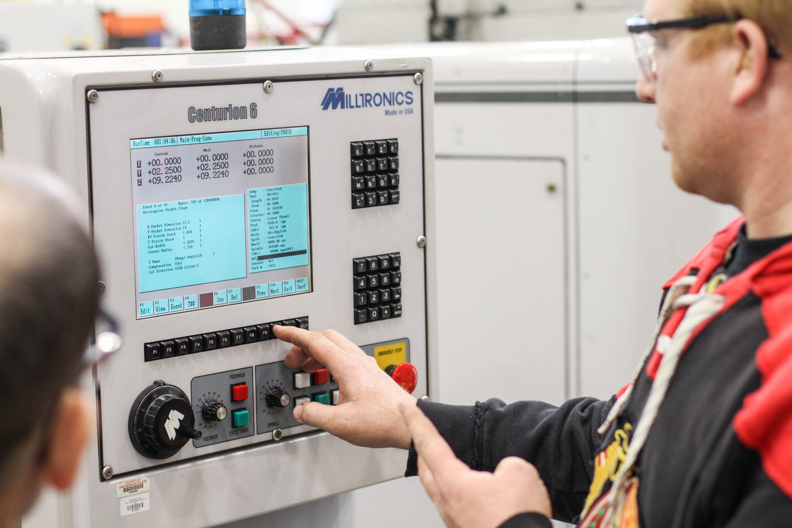 Person pressing buttons on a machine screen.