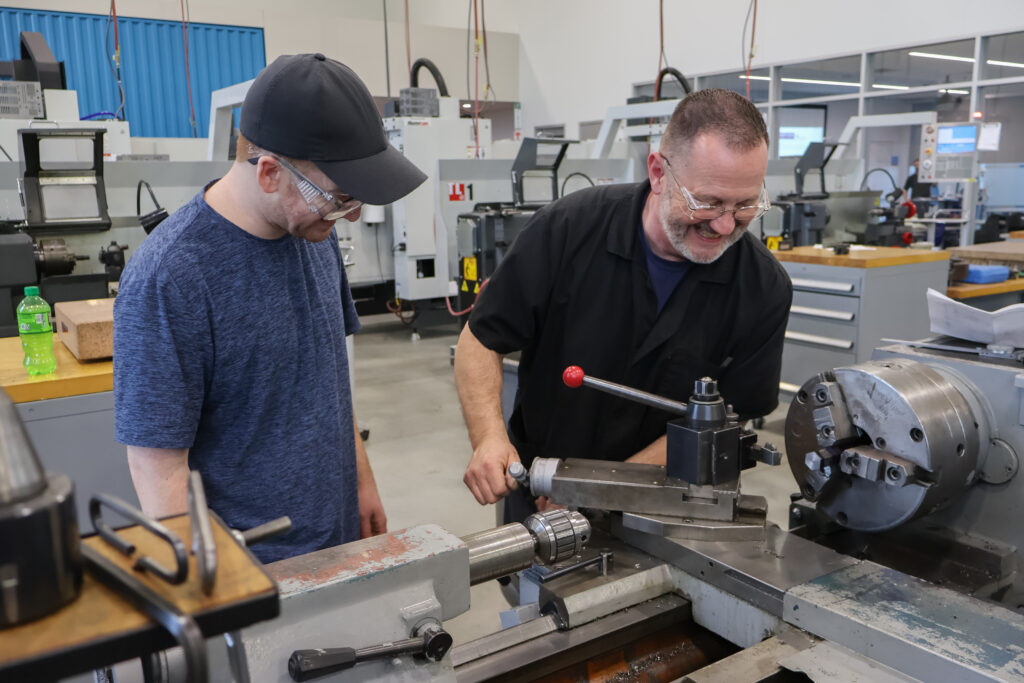 Two men around worktable