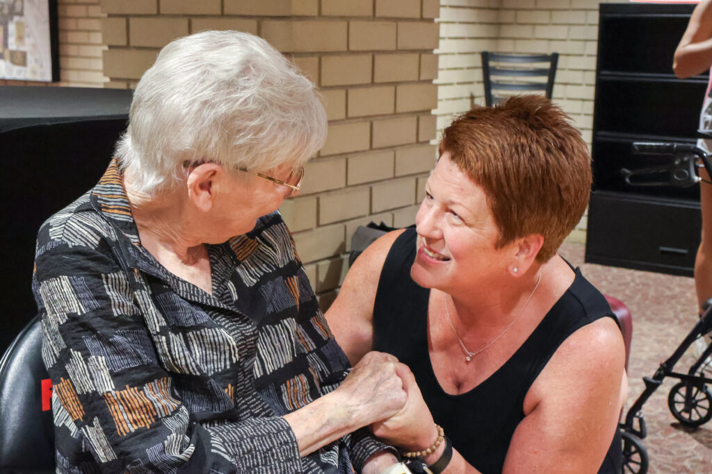 Woman assisting an elderly lady.