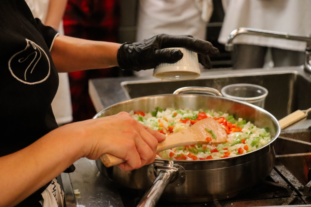 A person cooking on a stove-top.