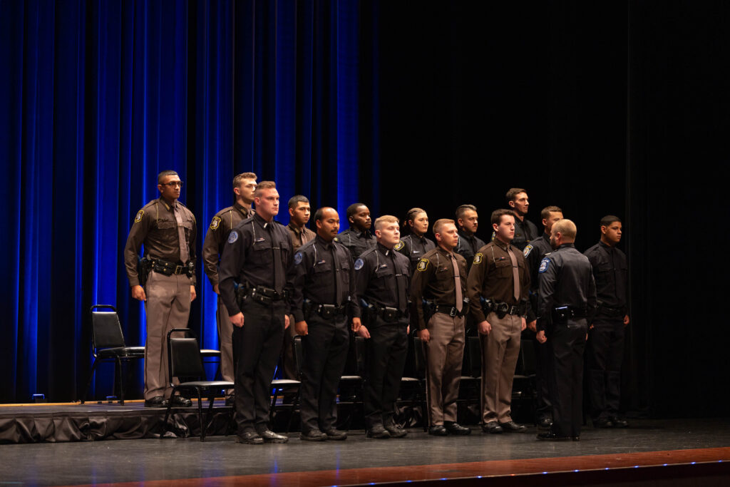 A line of policemen standing proudly.