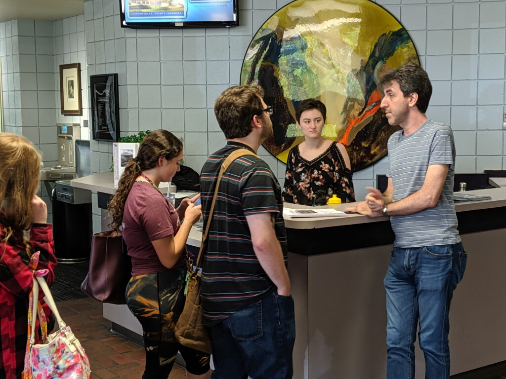 People gathered at a front desk.
