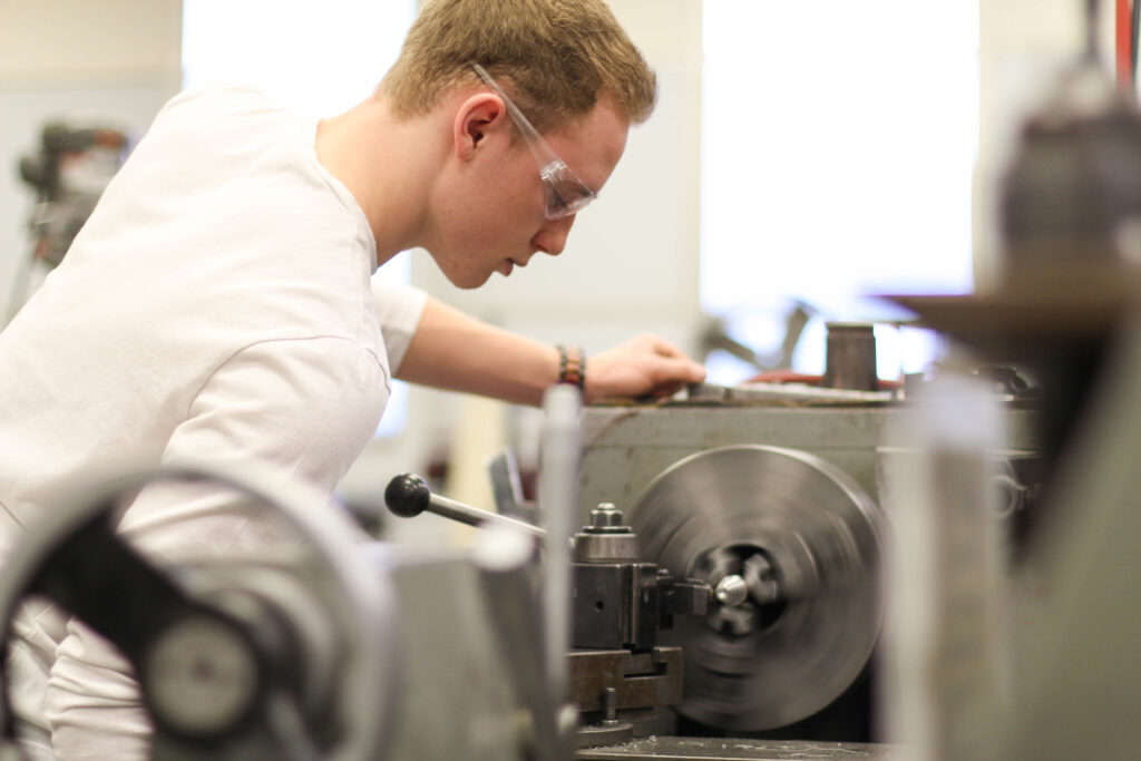 Engineering student using machine.