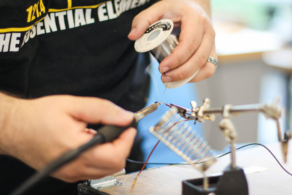 Person putting together a wire system.