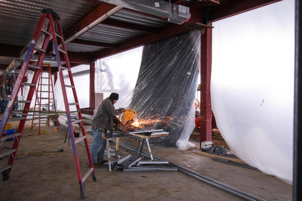 Man working saw at construction site
