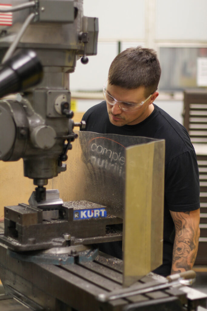 Man watching over a machine working.