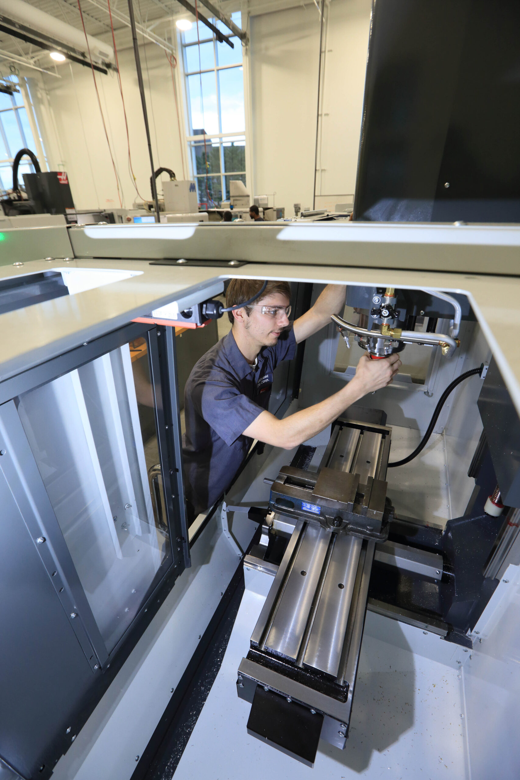 Man working on large manufacturing machine