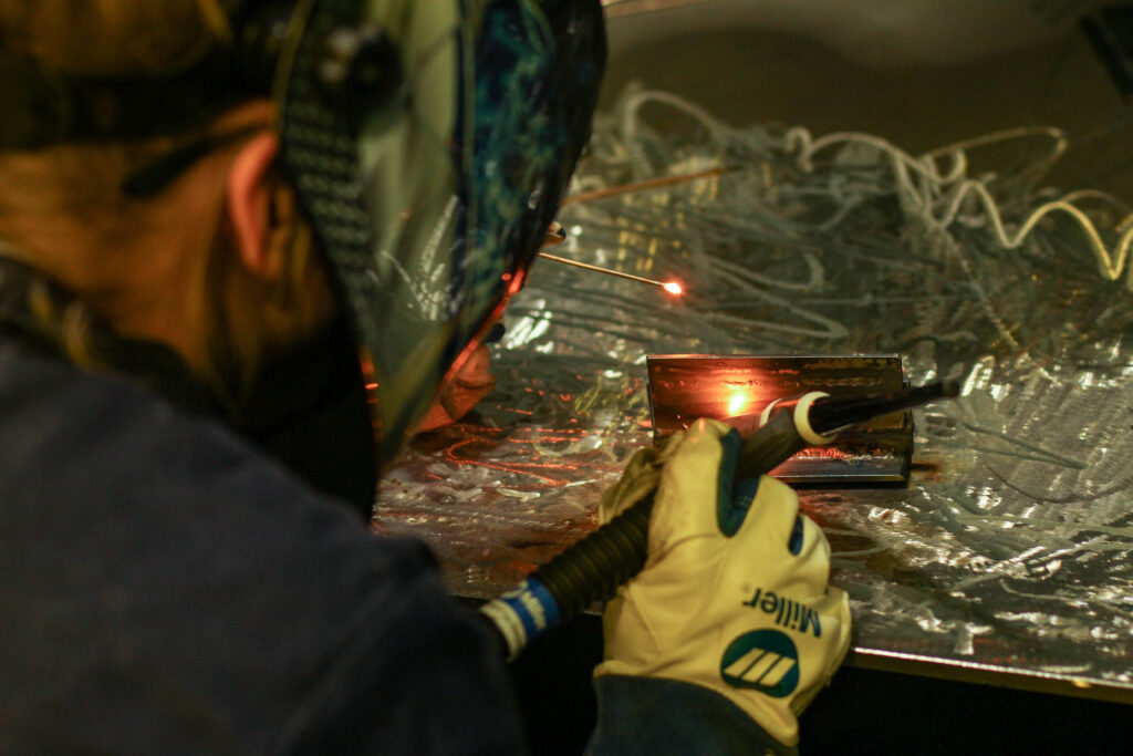 Person with mask on welding object
