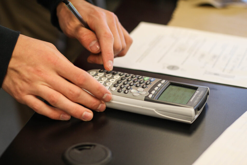 Hands working on a calculator