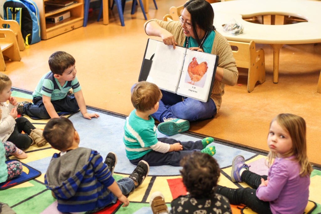 Woman reading to a class of children.