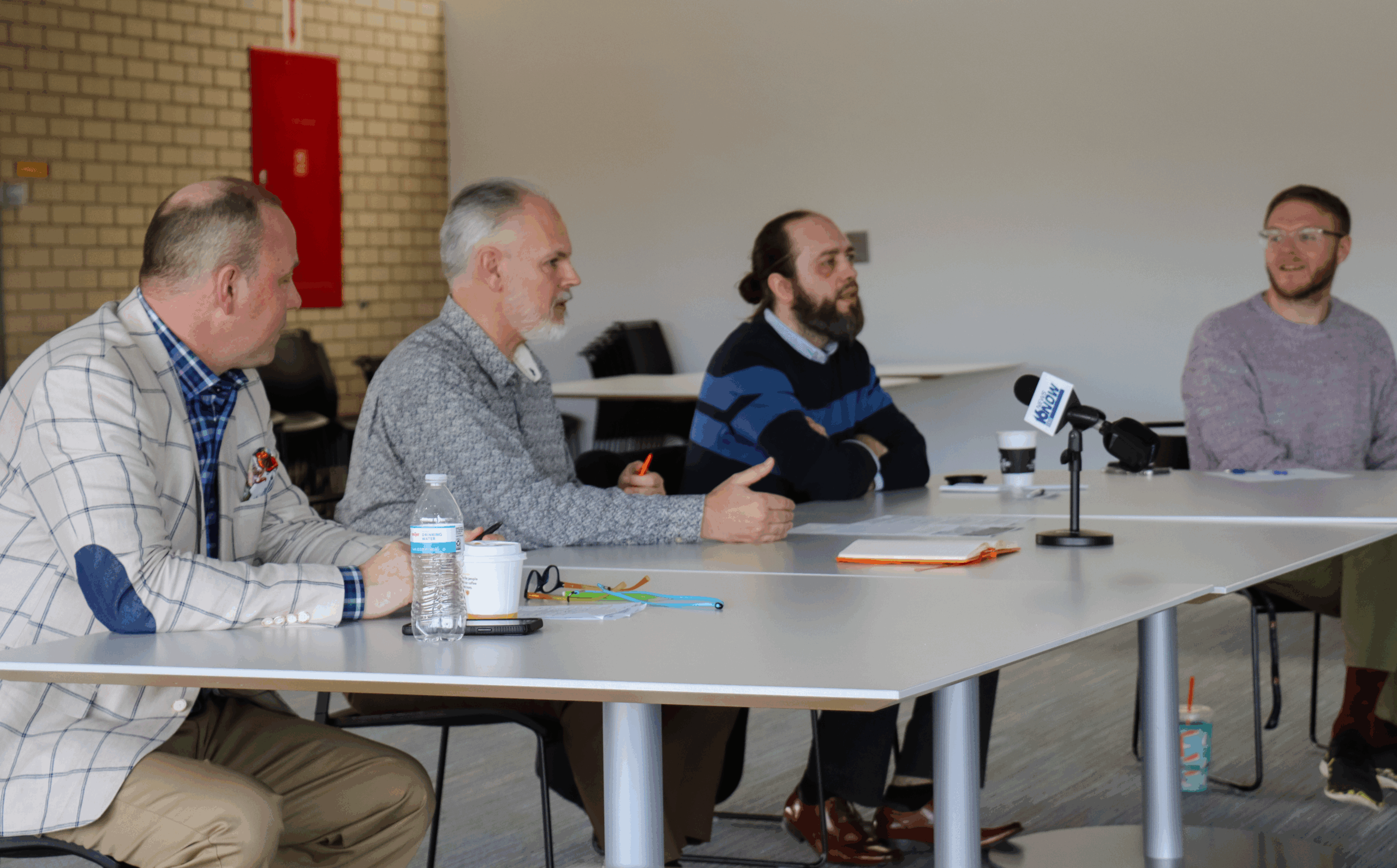 Men sitting at a table speaking