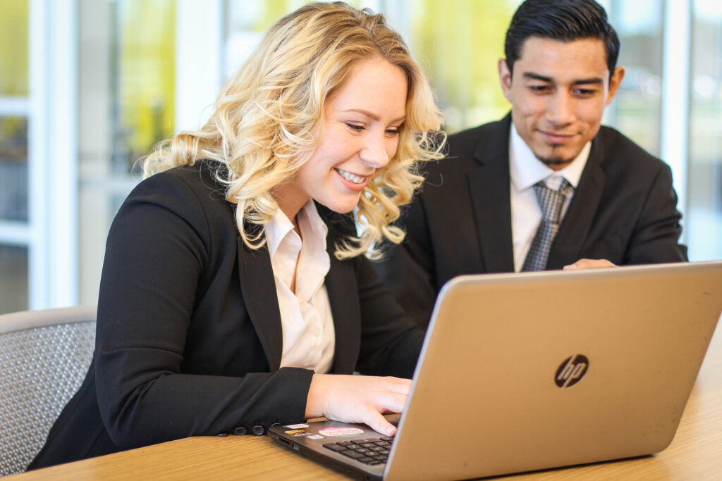 Two business people working on a laptop