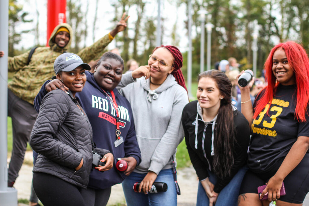 Several college girls posing together and smiling