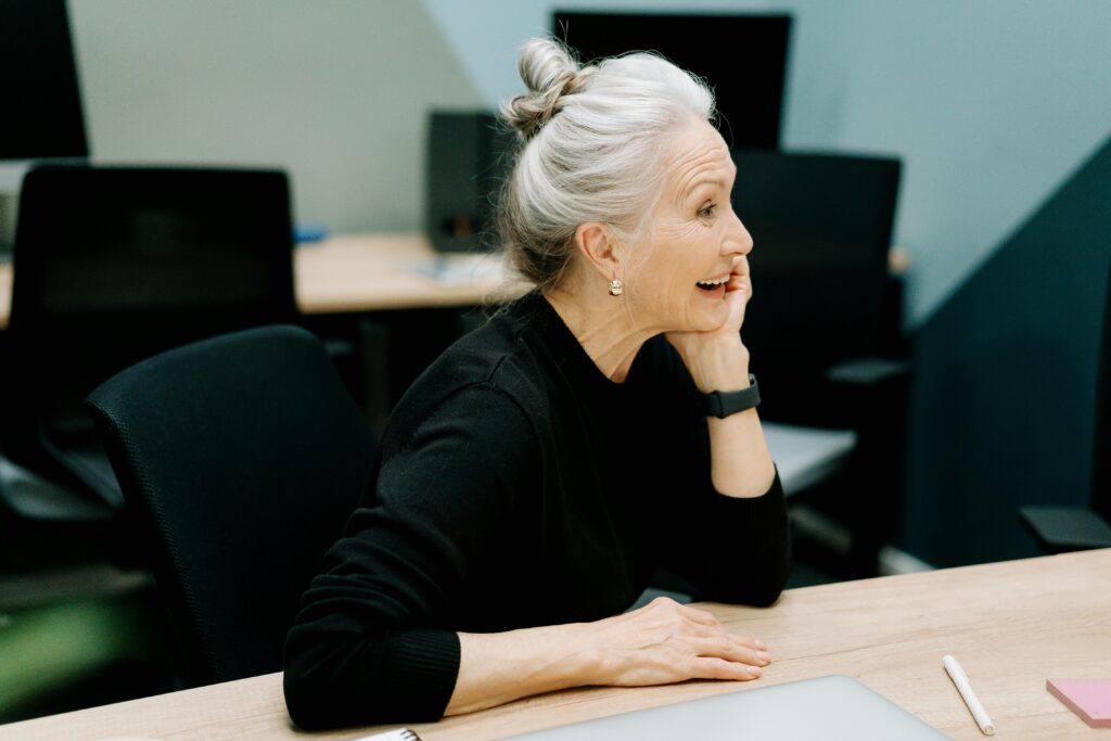 Smiling older woman sitting at table
