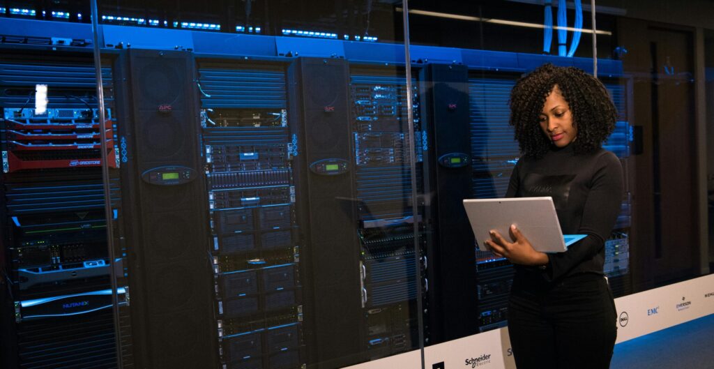 Woman in front of many servers on a laptop