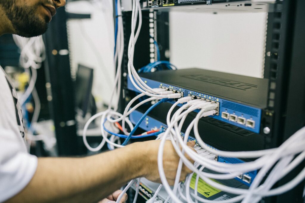 Network engineer working on cables on a server