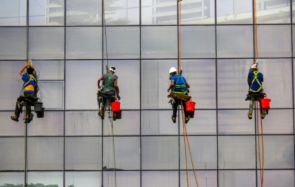 Workers cleaning windows of tall building