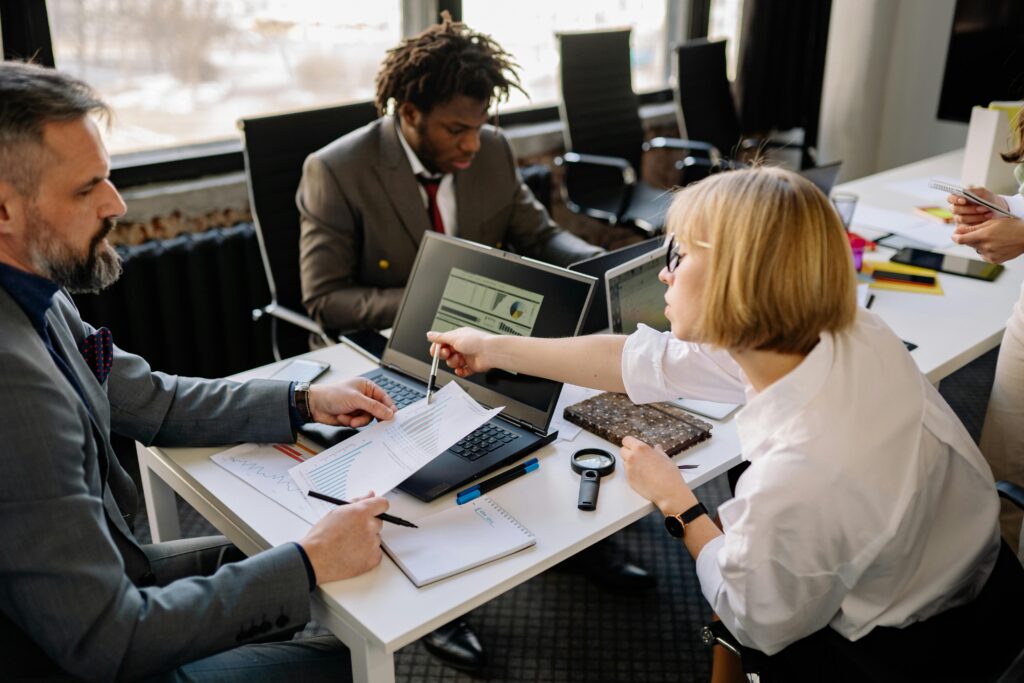 Business people meeting around a table and looking at papers